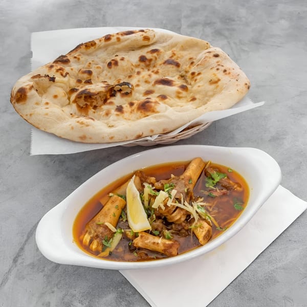 Shahi Restaurant's Indian dish, Nihari, with tender meat and bone marrow in a rich gravy, served with naan.